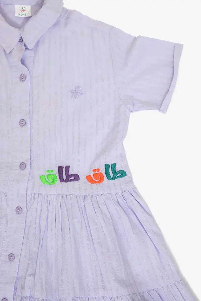 -closeup-embroidered-colorful-arabic-letters-on-purple-dress.webp