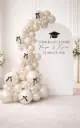 Elegant graduation backdrop with balloon garlands and bows